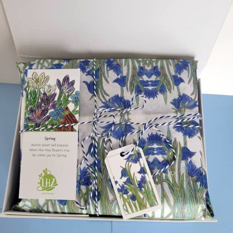 The tissue paper is a thick stock and it can be used in a variety of ways --wrapping a package, or as a gift box or gift bag liner.  In the photo above, the gift is wrapped in the tissue paper and placed inside a plain white gift box.
