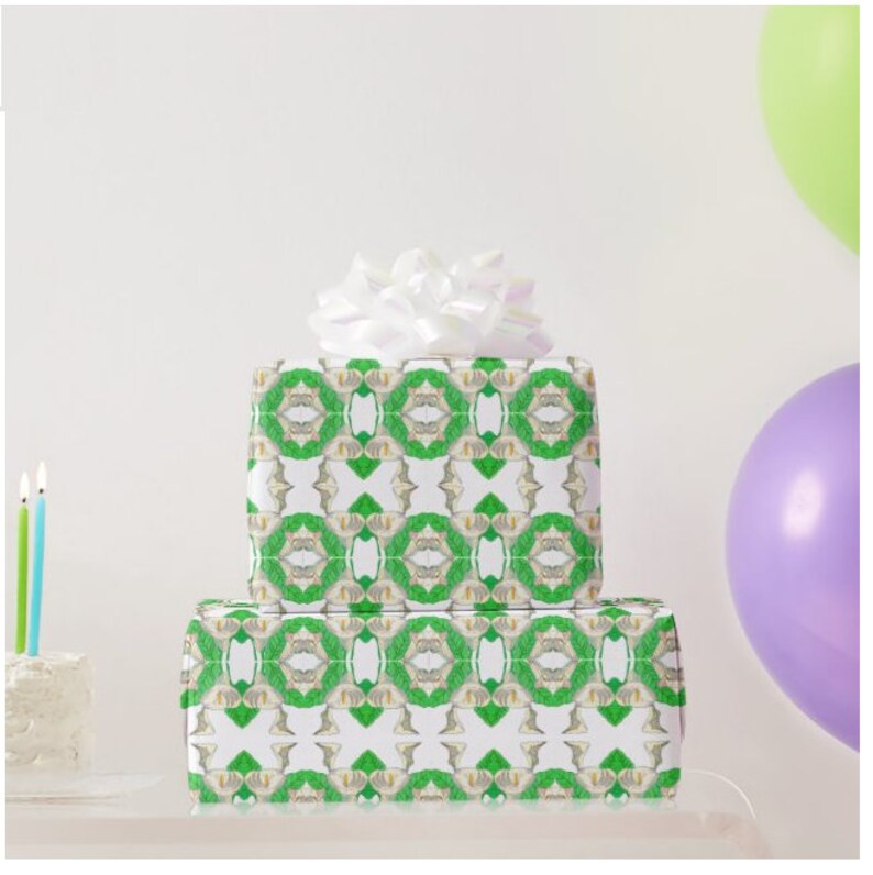 The gift wrap is a lovely pattern for wrapping wedding, shower or birthday gifts. Shown above: Two stacked boxes wrapped in the paper. The top box has a white bow on top. The boxes are on a clear surface with a purple balloon and a green balloon in the background.