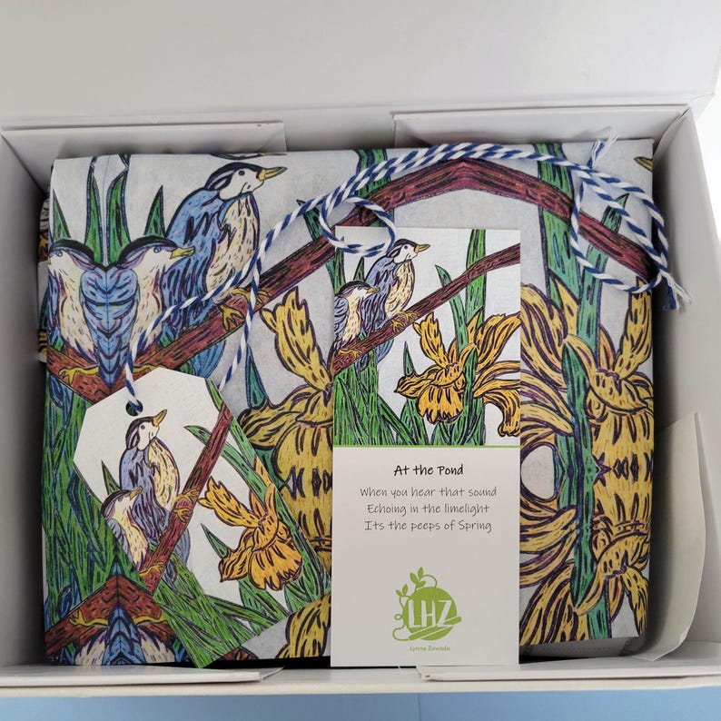 The Bird and Iris Tissue Paper Kit features five large sheets of my own tissue paper design of blue birds and yellow iris flowers. The design was created from my own original hand drawn illustration. In addition to the paper, the kit also has five matching gift tags and stickers, a small spool of twine and a haiku bookmark greeting tag. Shown above: a gift wrapped in the paper and placed in a larger gift box.