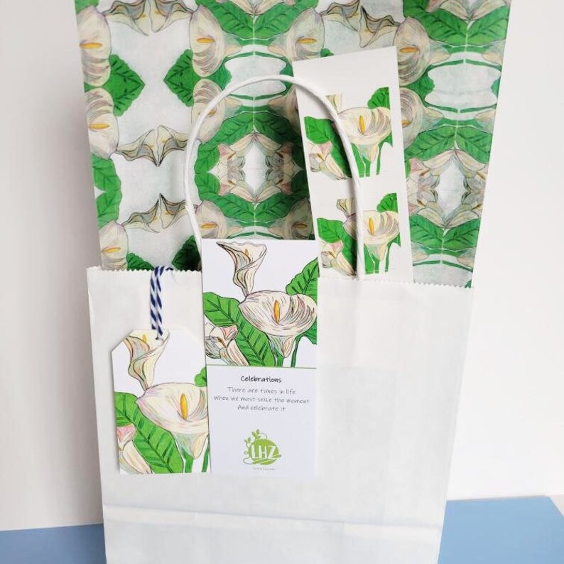 The paper is excellent as a gift bag liner. Shown above: the paper lines a plain white gift bag. The gift tag and bookmark hang from the edge of the bag, near the handle.