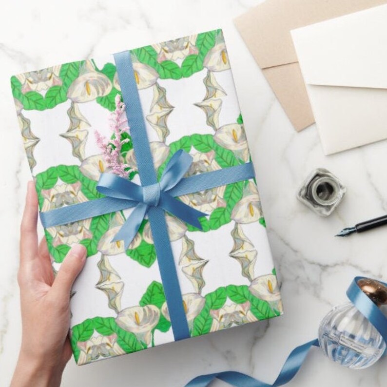 Shown above: a medium sized gift box wrapped in the paper and tied with a blue satin ribbon. (Ribbon not included).