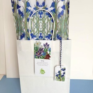 The tissue paper is an excellent liner for any gift bag. Shown above: the paper in a plain white gift bag. The haiku bookmark and gift tag hang from the top edge of the bag, near the bag's handles.