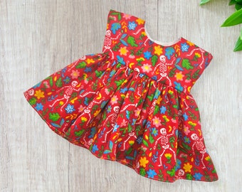 Dolls dress with Halloween skeletons and flowers on a red background, fits 18 inch baby dolls, Build a Bear, Reborn babies and many more.