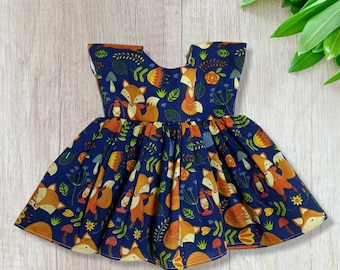 Foxes on a navy background dolls dress, fits 18 inch baby dolls, Build a Bear, Reborn babies and many more.