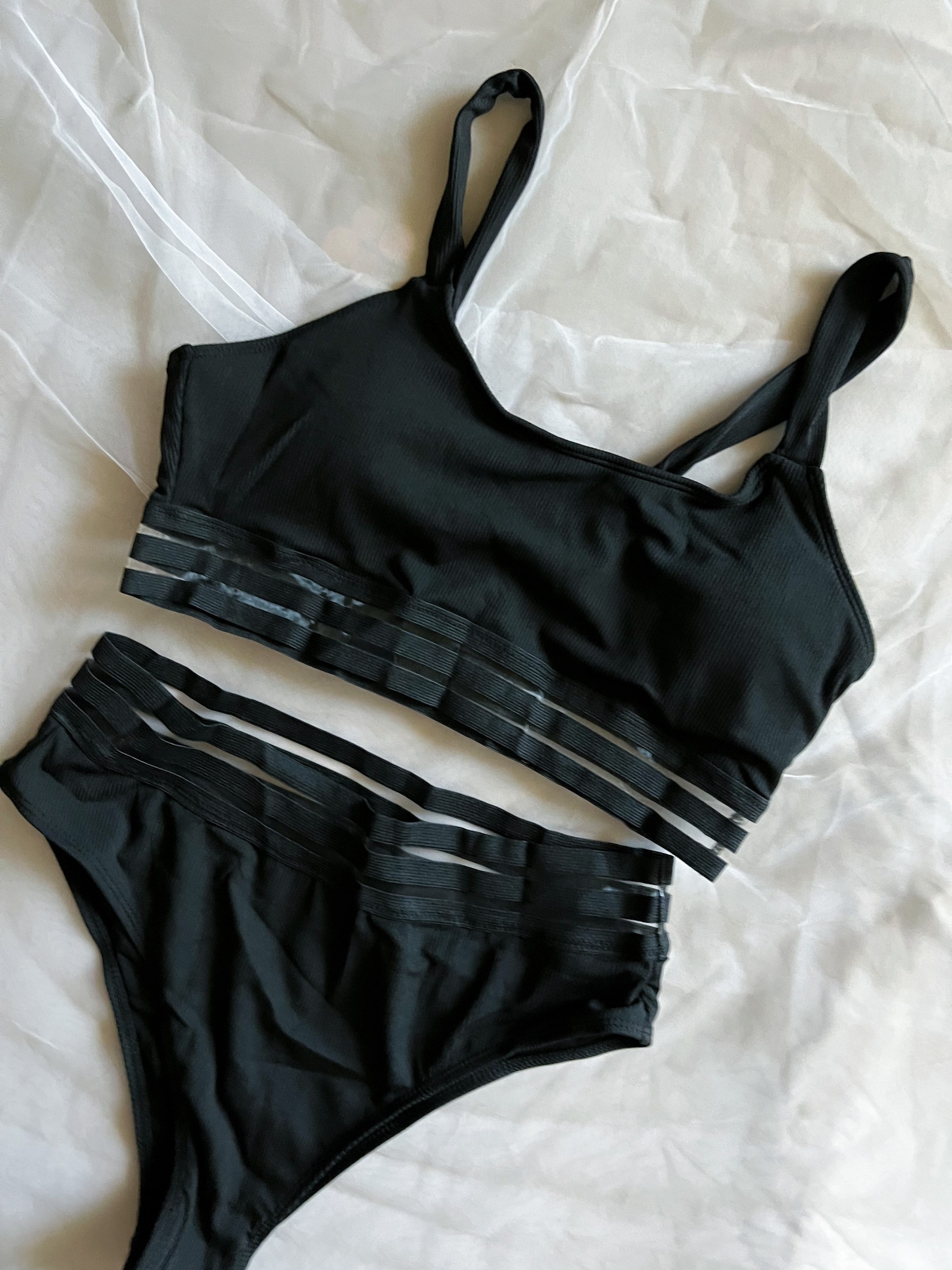 Two-piece goth swimsuit with sheer striped elastic bands, featuring a sporty bralette top and high-waist cheeky bottoms.