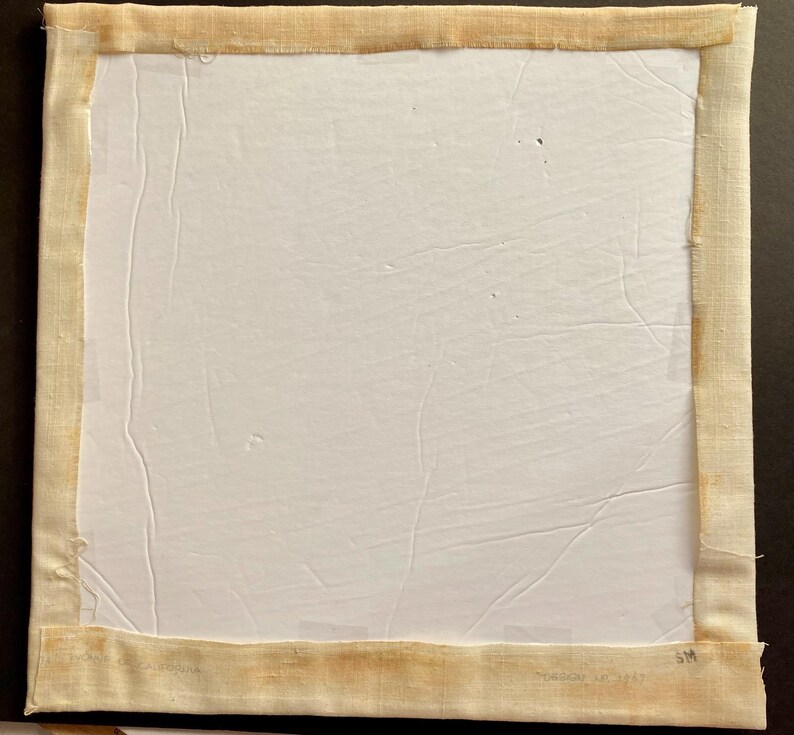 May include: A white canvas with a beige fabric border. The fabric border has a label that reads "Made in Italy".