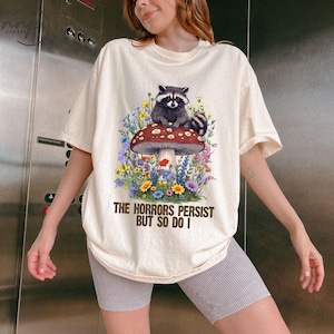 Comfort Colors® The Horrors Persist But So Do I shirt, Raccoon Mental Health shirt, Meme Shirt, Anxiety Tee, Oppossum Gift, Raccoon Gift