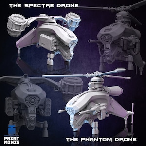 May include: Two 3D printed models of futuristic drones, one labeled "The Spectre Drone" and the other "The Phantom Drone". Both drones are gray and have a similar design with rotating blades, multiple guns, and a large, round, central body.
