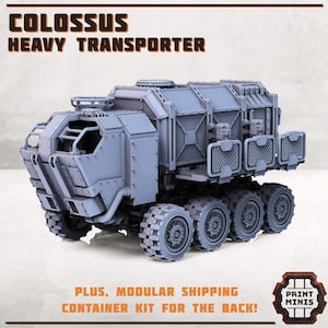 May include: A gray, futuristic, heavy transporter vehicle with a large cargo bed and six wheels. The vehicle has a detailed design with a cage-like structure on the front and a series of compartments on the back. The text "COLOSSUS HEAVY TRANSPORTER" is printed in black at the top of the image. The text "PLUS, MODULAR SHIPPING CONTAINER KIT FOR THE BACK!" is printed in black at the bottom of the image. The text "PRINT MINIS" is printed in black on a white background in a circular logo at the bottom right of the image.