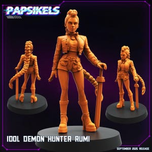 May include: Orange-colored figurine of a female character, holding a sword, with a braid and wearing a jacket, shorts, and boots. The text "IDOL DEMON HUNTER RUMI" is at the bottom, with "PAPSIKELS" at the top. The figurine is on a black base.