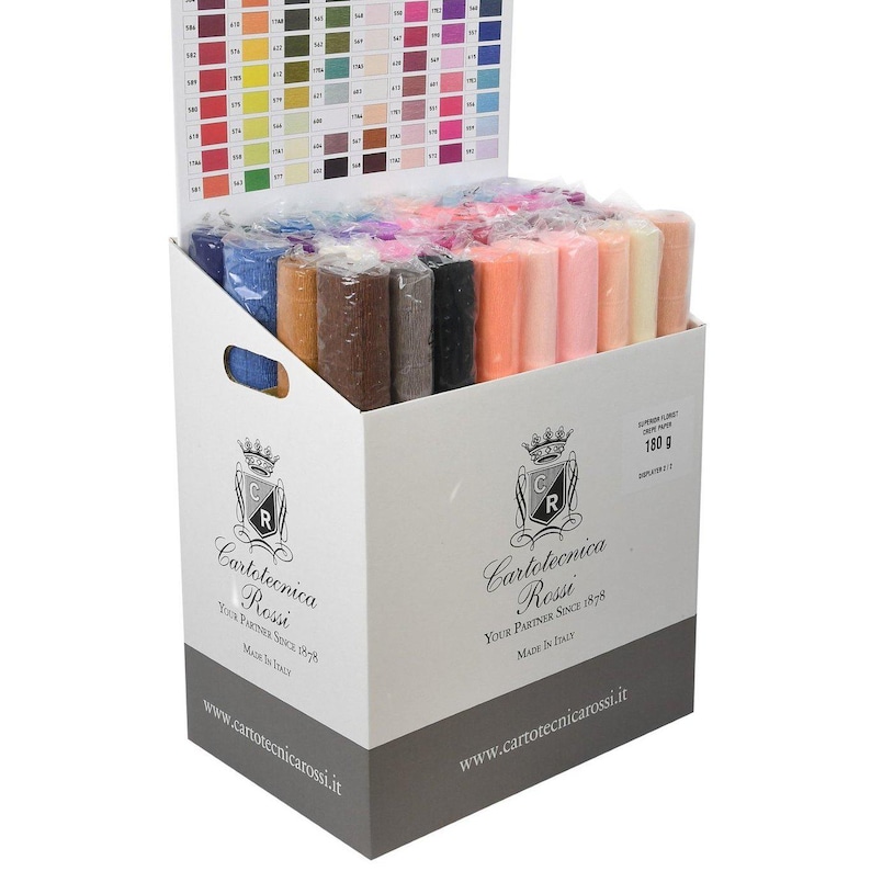 May include: A white cardboard display box filled with multiple rolls of colourful crepe paper. The box features the Cartotecnica Rossi logo, the text "Superior Florist Crepe Paper 180 g", and a colour reference chart attached to the back panel.