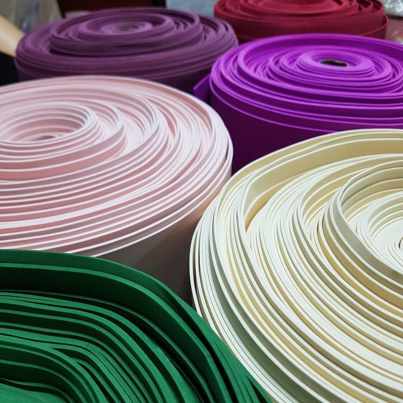 Various colors of 2mm EVA foam rolls displayed on shelves, waterproof craft foam for DIY projects and giant flower creations