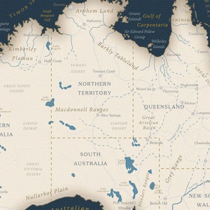 May include: A detailed map of Australia with state borders and major geographical features labeled. The map is in a vintage style with a beige background and blue lines. The map includes the Great Dividing Range, the Great Artesian Basin, the Nullarbor Plain, and the Macdonnell Ranges.