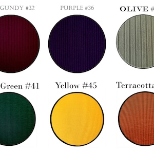 May include: Six fabric swatches in different colors, each with a different number. The colors are burgundy, purple, olive, dark green, yellow, and terracotta.