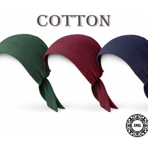 以下が含まれることがあります： 緑、バーガンディ、ネイビーブルーの3色の綿のヘッドカバー。各ヘッドカバーは、後ろに長く流れるテールで結ばれています。「COTTON」の文字がヘッドカバーの上に表示されています。円形のロゴが右下にあります。