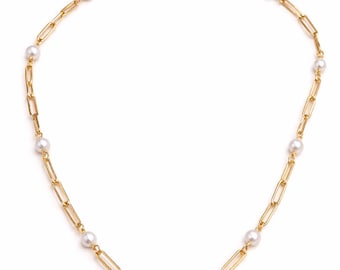 May include: A gold-colored chain necklace with a paperclip link design. The necklace is adorned with several white pearls evenly spaced along the chain. The clasp is a simple, round design.