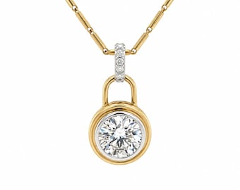 May include: A gold necklace featuring a round pendant with a central clear gemstone set in a gold and silver-toned bezel. The pendant is suspended from a gold chain by a small, silver-toned bail encrusted with tiny clear stones.
