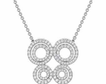 May include: A silver-toned necklace featuring a pendant composed of four circular rings arranged in a butterfly-like pattern. Each ring is encrusted with small, clear, sparkling stones. The pendant is attached to a delicate, thin silver-toned chain.