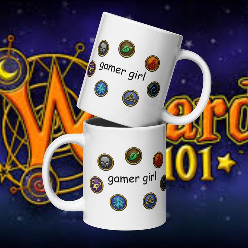 May include: Two white ceramic mugs stacked on top of each other. Each mug has the text "gamer girl" and various colorful circular icons. The background is a dark blue with orange and gold text.