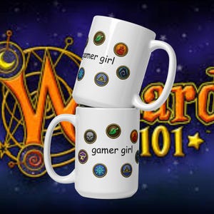 May include: Two white ceramic mugs stacked on top of each other. Each mug has the text "gamer girl" and various colorful circular graphics. The background features a stylized logo with the text "Wizard 101" in orange and yellow.