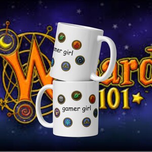 May include: Two white ceramic mugs stacked on top of each other. Each mug has the text "gamer girl" and various colorful circular graphics. The background is a dark blue with gold and orange accents and the words "Wizard 101".