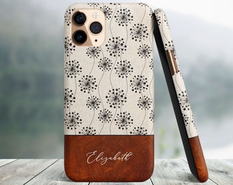 May include: A personalized phone case with a white background and a black dandelion pattern. The bottom of the case is brown wood with the name "Elizabeth" engraved in white.