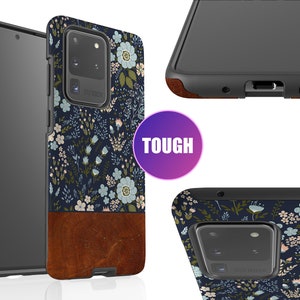 May include: A black phone case with a floral pattern and a brown leather accent. The case is designed to be tough and protective. The case is shown from multiple angles.