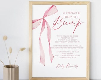 May include: A pink watercolor bow with a message from the bump. The message reads: "Thank you for being here for my mommy. It won't be long now till I come out of her tummy. I can't be there to thank you all but I know my mommy loves you all. I know you all can't wait until I'm here. So make some memories today and hold them dear! Baby Kennedy"