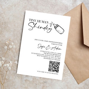 May include: A white baby shower invitation with black text. The invitation reads "Tiny Human Shindig" with a drawing of a baby bottle. The invitation includes the names "Josie & Adam" and details for the shower, including the date, time, location, and RSVP information. A QR code is included for the registry.