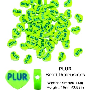 May include: A large quantity of bright green heart-shaped beads with the word "PLUR" printed in blue on each bead. The beads are arranged in a random pattern on a white background. The image also includes a close-up of a single bead and a bead with a hole in the center. The text "PLUR Bead Dimensions" is printed below the beads, along with the dimensions: Width: 19mm/0.74in, Height: 15mm/0.58in, Hole Size: 2mm.