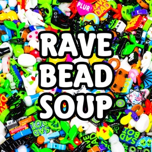 May include: A colourful collection of plastic beads with various shapes and designs, including letters, symbols, and cartoon characters. The beads are arranged in a random pattern and include the words "RAVE BEAD SOUP".