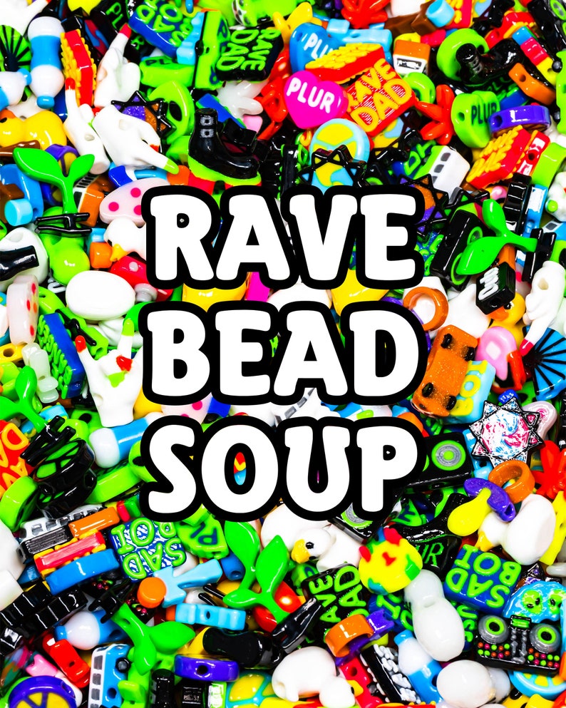 May include: A colorful collection of plastic beads with various shapes and designs, including letters, symbols, and cartoon characters. The beads are arranged in a random pattern and include the words "RAVE BEAD SOUP".