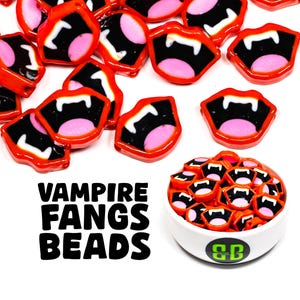 May include: A bowl filled with red and black vampire fang beads. The beads are shaped like open mouths with sharp teeth. The bowl is white with a green "CB" logo on the bottom. The text "Vampire Fangs Beads" is written in black letters on a white background.