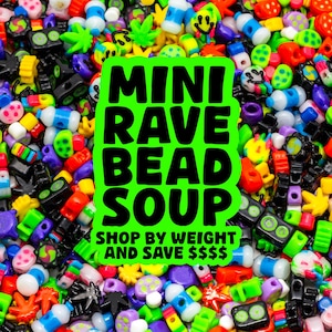 May include: A vibrant assortment of colorful beads in various shapes and sizes, including smiley faces, stars, and other novelty designs. A neon green sign reads "MINI RAVE BEAD SOUP" with the text "SHOP BY WEIGHT AND SAVE $$$" below.
