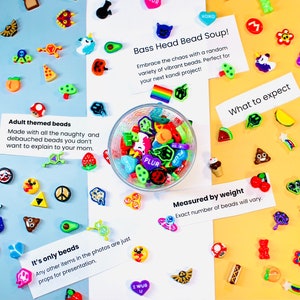 May include: A glass bowl filled with colorful plastic beads, with various themes, including adult-themed, and a rainbow. The bowl is surrounded by cards with text, including "Bass Head Bead Soup!" and "Adult themed beads".