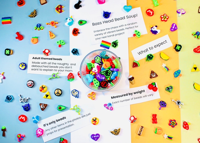 May include: A glass bowl filled with colorful plastic beads, with various themes, including adult-themed, and a rainbow. The bowl is surrounded by cards with text, including "Bass Head Bead Soup!" and "Adult themed beads".