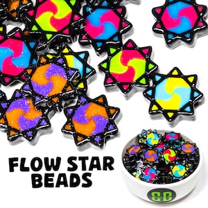 May include: A bowl of colorful star-shaped beads with a swirl design. The beads are black with a variety of colors, including purple, orange, yellow, blue, and pink. The text "FLOW STAR BEADS" is written below the bowl.