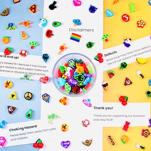May include: A bowl of colorful plastic beads with various designs, including smiley faces, hearts, and stars. The beads are arranged on a light blue, yellow, and orange background with cards that read "For ages 18 and up!", "Choking Hazard", "Defects", "Disclaimers", and "Thank you!"