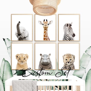 May include: Six framed animal prints featuring a baby elephant, giraffe, zebra, lion cub, hippo, and cheetah cub. The prints have a white background and are in wooden frames. The text "Custom Set" is written in cursive at the bottom.
