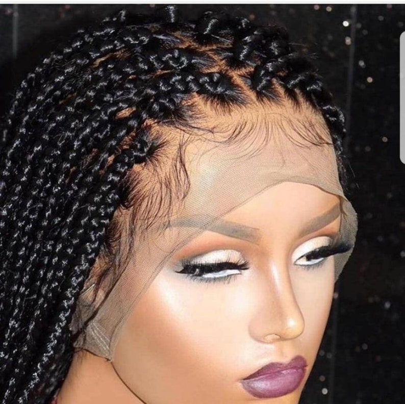 May include: A black braided wig with a lace front. The wig is styled in small braids and is ready to be installed.