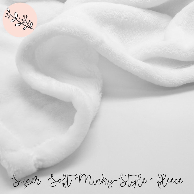 May include: Close-up of a white, soft, minky-style fleece fabric. The fabric is very soft and plush, and it would be perfect for a blanket or a baby's toy.