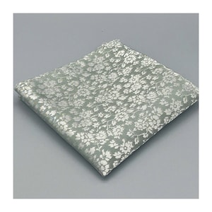 May include: A light green pocket square with a white floral pattern.