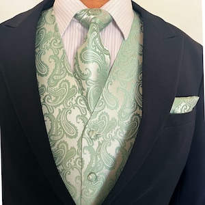 May include: A green paisley patterned vest and matching tie with a black suit jacket.