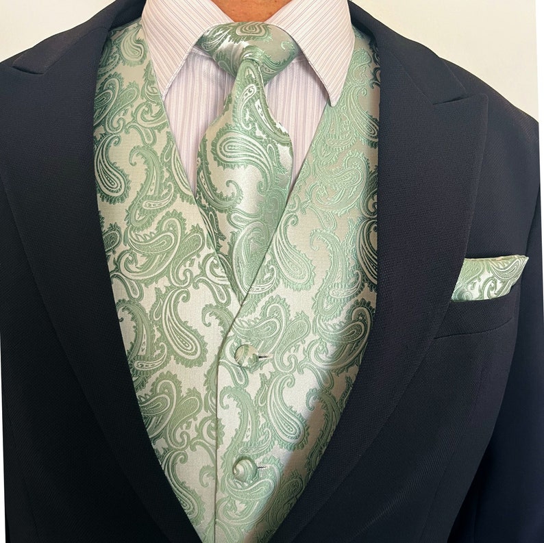 May include: A green paisley patterned vest and matching tie with a black suit jacket.