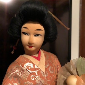 Geisha Performer with a flower bouquet on platform