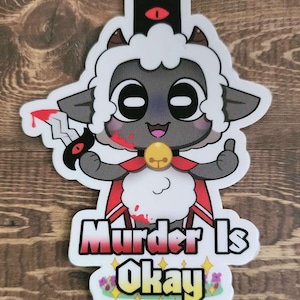 May include: A white cartoon sheep with black horns and a red cape holding a bloody knife. The sheep has a black eye with a red pupil and a yellow bell around its neck. The text "Murder Is Okay" is written below the sheep in a red, white, and yellow font.