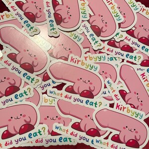 May include: A pile of pink and red stickers with a cartoon character and the text "What did you eat?" repeated on each sticker.