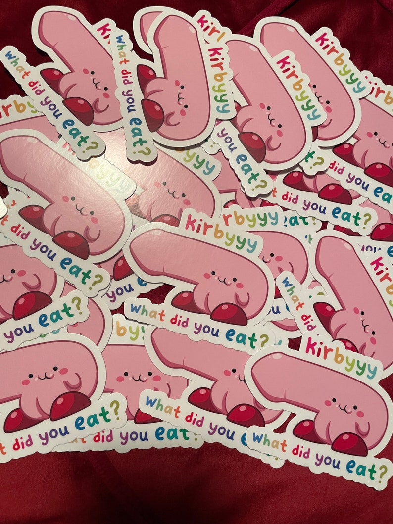 May include: A pile of pink and red stickers with a cartoon character and the text "What did you eat?" repeated on each sticker.