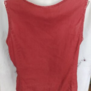 May include: A sleeveless, red tank top with a scoop neck.