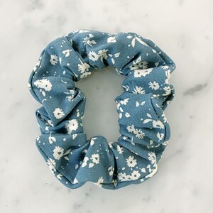 May include: A blue and white floral patterned scrunchie.